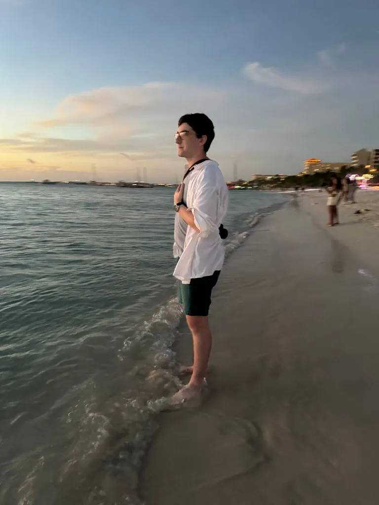 Dov standing in the surf at sunset